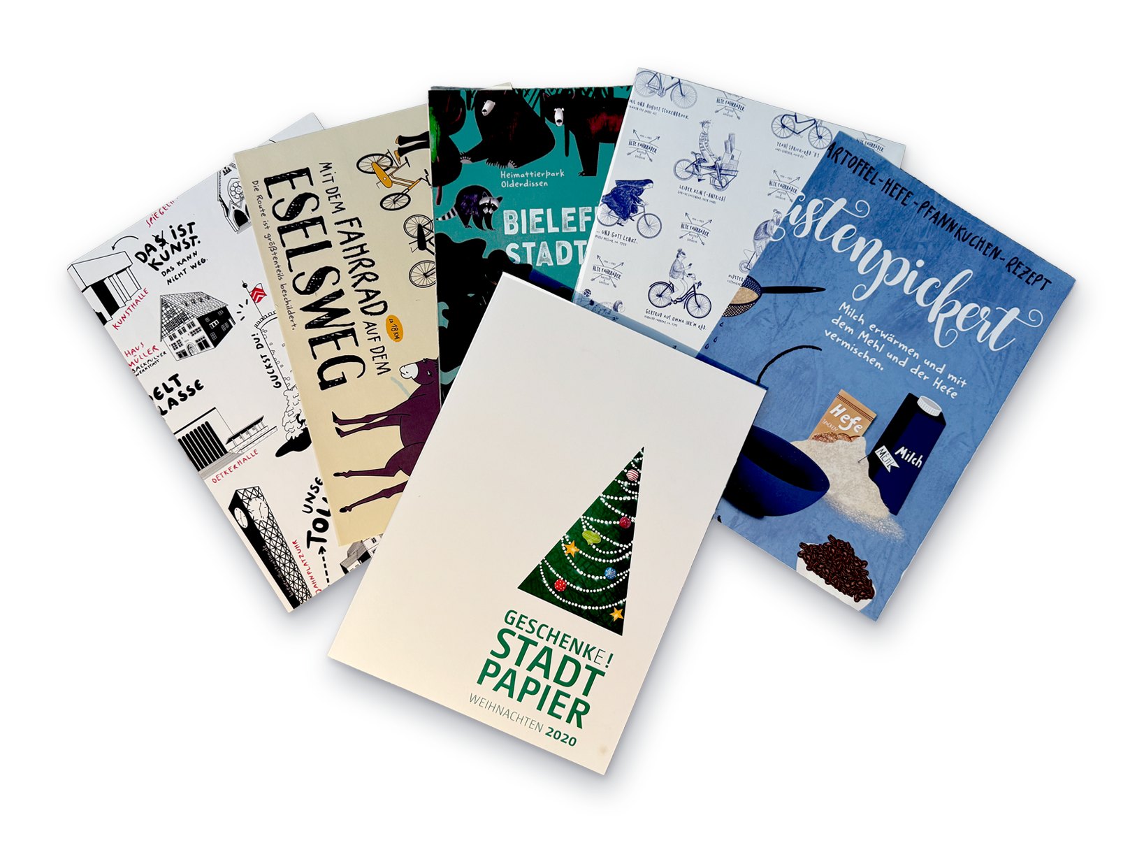 Die Geschenkpapierbögen aufgefächert, obenauf das Cover „Geschenke! Stadtpapier – Weihnachten 2020“