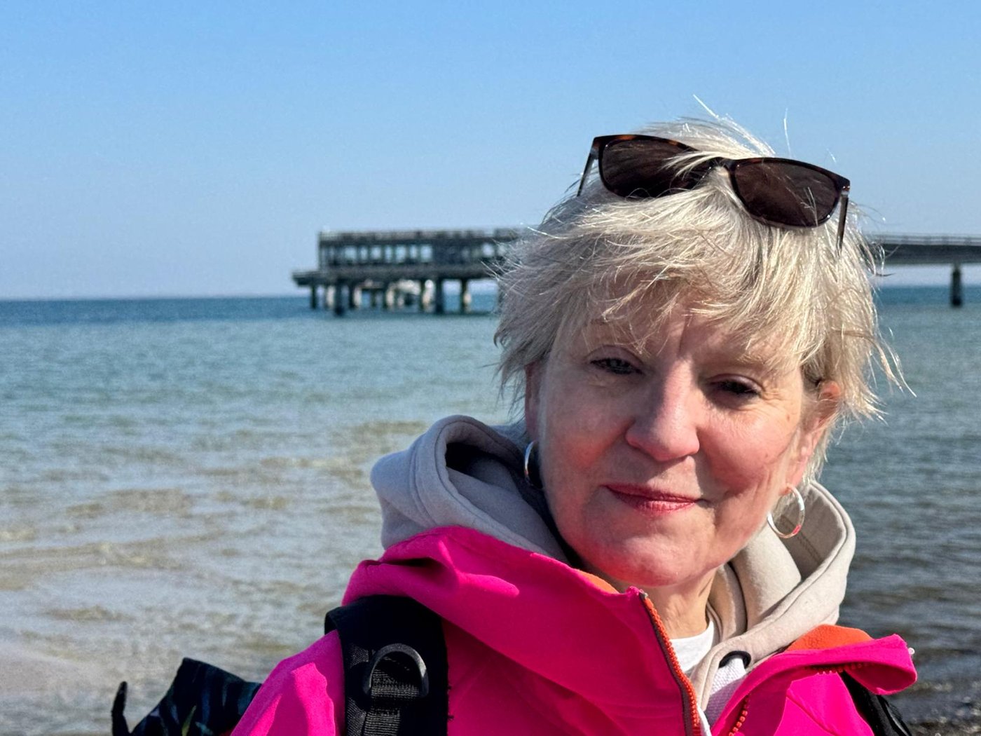 Petra Breuer am Meer, im Hintergrund eine Seebrücke